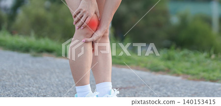 Young adult female runner with knee pain from ACL injury or patellofemoral syndrome. woman having joint ache, ligament tear or patellar tendinitis during running. Sports medical and healthcare concept 140153415