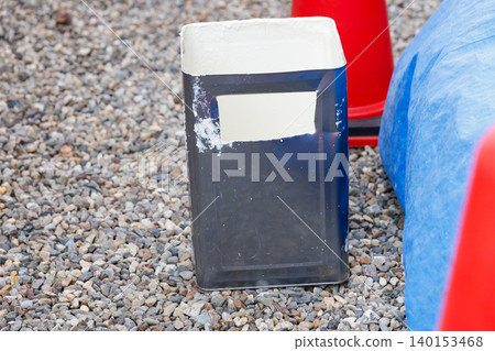 Empty paint cans used for exterior wall painting. These are opened and have holes punched in them. Empty paint cans used for exterior wall painting. These are opened and have holes punched in them. 140153468