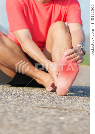 Young adult male runner suffering from acute plantar fasciitis pain during running workout. Man holding his foot due to heel inflammation and sports injury. Medical and healthcare concept 140153506