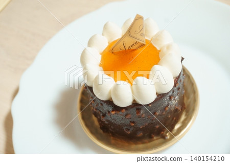 Chocolate cake topped with orange sauce Chocolate cake topped with orange sauce 140154210