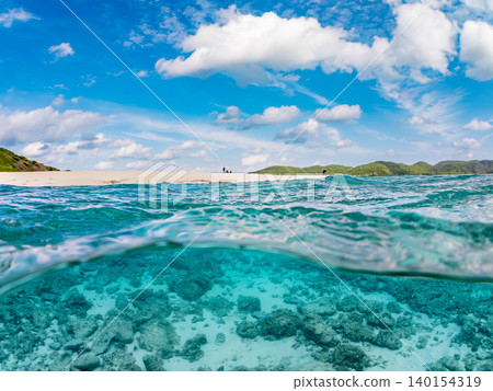 A half-submerged photograph of the beautiful white sand beach on the uninhabited island of Kabi Island. Kabi Island, Okinawa Prefecture, Shimajiri District, Kerama Islands, Zamami Island - 2025 A half-submerged photograph of the beautiful white sand beach on the uninhabited island of Kabi Island. Kabi Island, Okinawa Prefecture, Shimajiri District, Kerama Islands, Zamami Island - 2025 140154319
