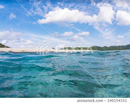 A half-submerged photograph of the beautiful white sand beach on the uninhabited island of Kabi Island. Kabi Island, Okinawa Prefecture, Shimajiri District, Kerama Islands, Zamami Island - 2025 A half-submerged photograph of the beautiful white sand beach on the uninhabited island of Kabi Island. Kabi Island, Okinawa Prefecture, Shimajiri District, Kerama Islands, Zamami Island - 2025 140154331