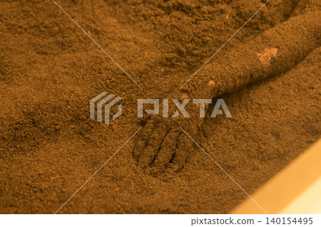 A woman's hands while taking an enzyme bath A woman's hands while taking an enzyme bath 140154495