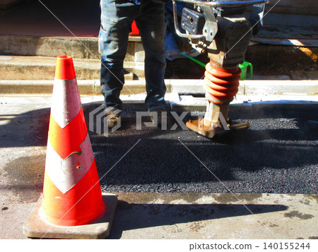A scene from a road asphalt pavement repair work site. A scene from a road asphalt pavement repair work site. 140155244