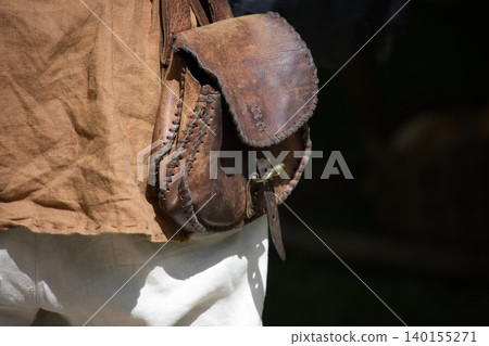 Close-up of a rustic leather pouch with intricate stitching and a brass clasp Close-up of a rustic leather pouch with intricate stitching and a brass clasp 140155271