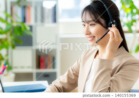 Female operator working in the office Female operator working in the office 140155369