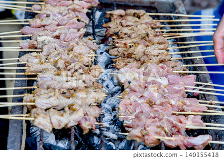 Traditional meTraditional meat satay skewers grilling on charcoal at satay skewers grilling on charcoal Traditional meTraditional meat satay skewers grilling on charcoal at satay skewers grilling on charcoal 140155418