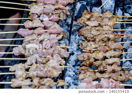 Traditional meTraditional meat satay skewers grilling on charcoal at satay skewers grilling on charcoal Traditional meTraditional meat satay skewers grilling on charcoal at satay skewers grilling on charcoal 140155419
