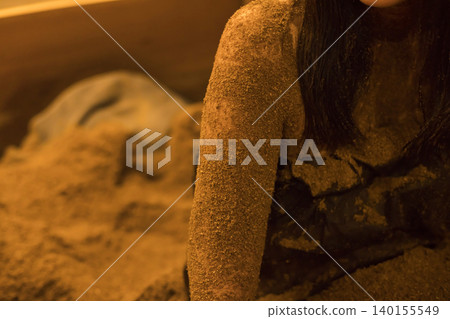 A woman in an enzyme bath; her arms covered in sawdust. A woman in an enzyme bath; her arms covered in sawdust. 140155549