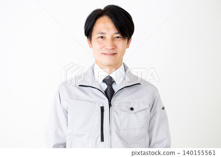 Middle-aged male businessman in gray work clothes, white background. Middle-aged male businessman in gray work clothes, white background. 140155561