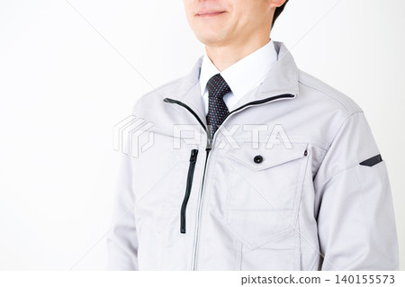 Middle-aged male businessman in gray work clothes, white background. Middle-aged male businessman in gray work clothes, white background. 140155573