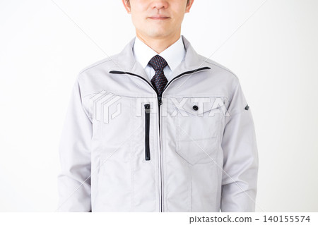 Middle-aged male businessman in gray work clothes, white background. Middle-aged male businessman in gray work clothes, white background. 140155574