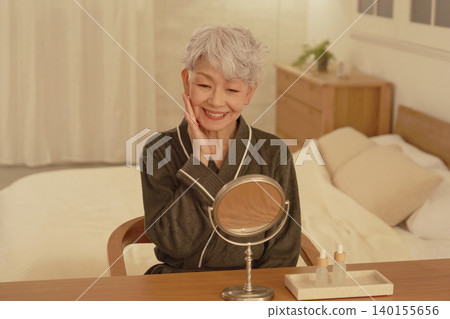 Senior woman's nighttime facial care Senior woman's nighttime facial care 140155656