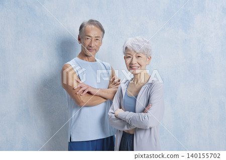 Portrait of senior man and woman exercising, looking at camera Portrait of senior man and woman exercising, looking at camera 140155702