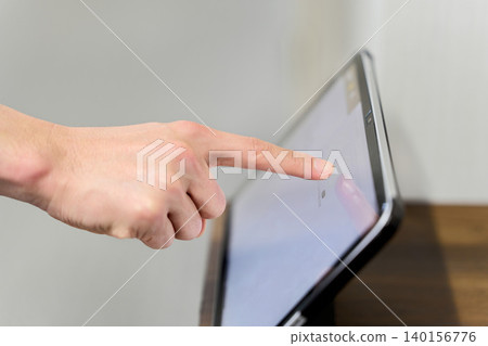 Fingers entering data into a tablet for attendance management Fingers entering data into a tablet for attendance management 140156776