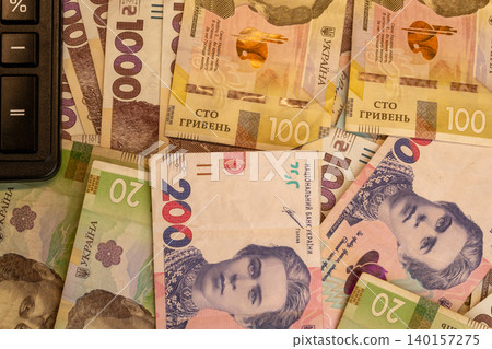 Background of various Ukrainian hryvnia banknotes with calculator close up Background of various Ukrainian hryvnia banknotes with calculator close up 140157275