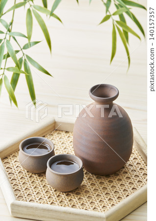A sake set featuring a sake cup and carafe, representing the image of Japanese sake. A sake set featuring a sake cup and carafe, representing the image of Japanese sake. 140157357