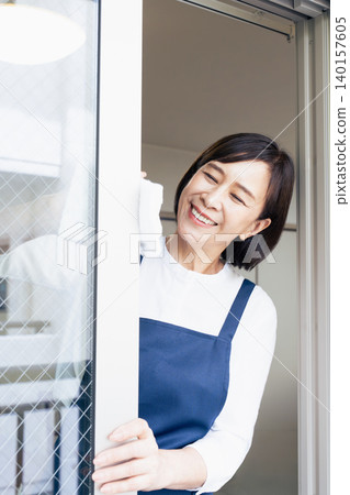 A woman cleaning windows A woman cleaning windows 140157605