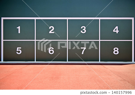 Close-up view of a numbered soccer practice target board with a geometric graphic background. 140157996