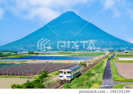 Ibusuki-Makurazaki Line: Kiha 40 train running with Mount Kaimon in the background. Ibusuki-Makurazaki Line: Kiha 40 train running with Mount Kaimon in the background. 140158199