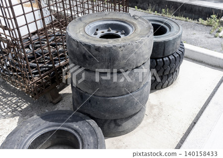 Construction machine tire with worn tread on wheel Construction machine tire with worn tread on wheel 140158433