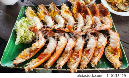 Grilled Giant River Prawns with Creamy Fat on Banana Leaf Plate Grilled Giant River Prawns with Creamy Fat on Banana Leaf Plate 140158439