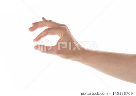 Male hand hold transparent pill isolated on white Male hand hold transparent pill isolated on white 140158769