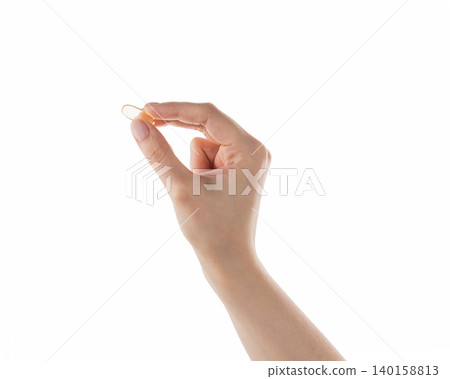 Female hand hold transparent pill isolated on white Female hand hold transparent pill isolated on white 140158813