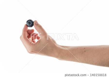 Man hand hold big blueberry isolated on white Man hand hold big blueberry isolated on white 140158818