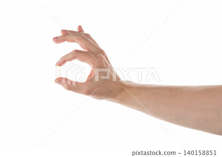 Male hand hold transparent pill isolated on white Male hand hold transparent pill isolated on white 140158851
