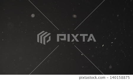 Slow motion real dust particles floating mid air over dark background 140158875