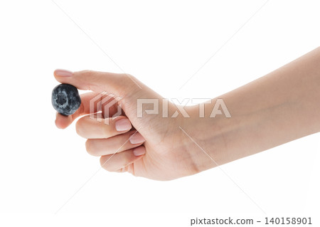 Female hand hold big blueberry isolated on white 140158901