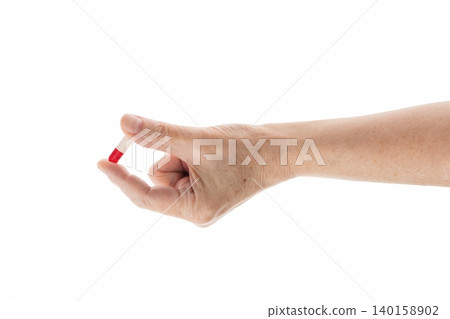 Mid aged female hold red and white pills isolated on white Mid aged female hold red and white pills isolated on white 140158902