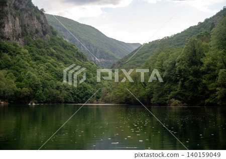 Matka Canyon view with reflection on water in Skopje, North Macedonia during cloudy day Matka Canyon view with reflection on water in Skopje, North Macedonia during cloudy day 140159049