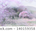 A beautiful landscape of cherry trees and mountains shrouded in mist. 140159358