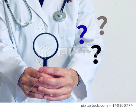 A female doctor holding a magnifying glass and a question mark. A female doctor holding a magnifying glass and a question mark. 140160774