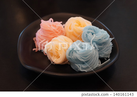Khanom jeen five rolled into five pieces, placed on a black ceramic plate on a black background, food, object, decor, copy space Khanom jeen five rolled into five pieces, placed on a black ceramic plate on a black background, food, object, decor, copy space 140161143