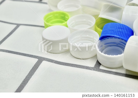 Bottle caps scattered haphazardly Bottle caps scattered haphazardly 140161153