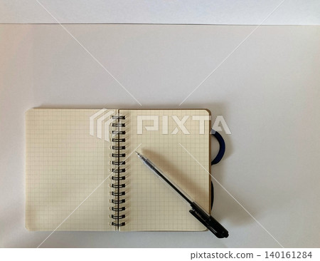 Open note and ballpoint pen 140161284