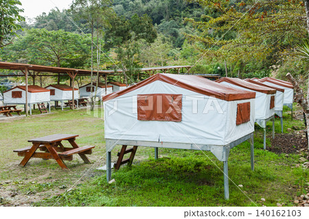 Elevated canvas tents at forest campsite in Taiwan Elevated canvas tents at forest campsite in Taiwan 140162103