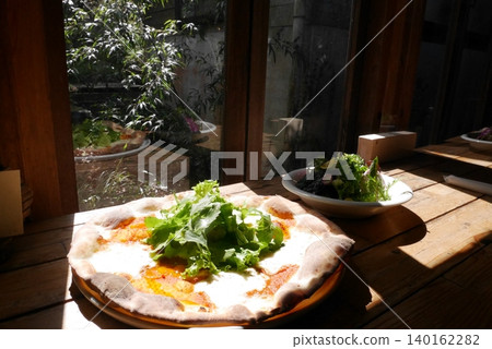 Pizza from a stylish cafe 140162282