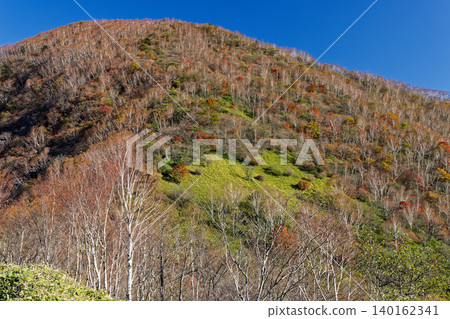 Autumn foliage of Mt. Akagi and Mt. Kurohime as seen from the hiking trail to Mt. Komagatake. Autumn foliage of Mt. Akagi and Mt. Kurohime as seen from the hiking trail to Mt. Komagatake. 140162341