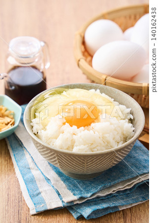 Egg over rice: A breakfast of white rice and a raw egg served in a bowl. Egg over rice: A breakfast of white rice and a raw egg served in a bowl. 140162438