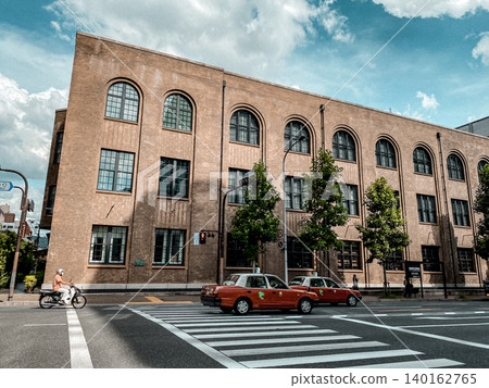 Streetscape lined with brick warehouses and cars Streetscape lined with brick warehouses and cars 140162765
