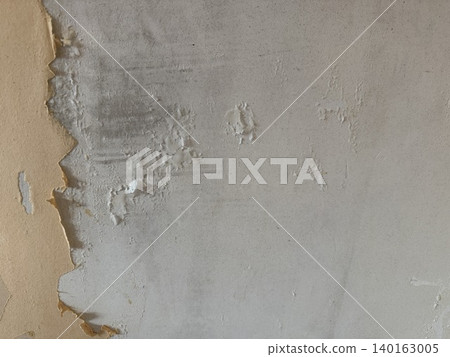 Peeling paint on a weathered wall creates a textured and aged background for design purposes 140163005