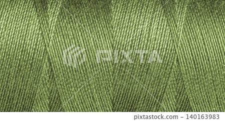 Close-up texture of green sewing threads on a spool Close-up texture of green sewing threads on a spool 140163983