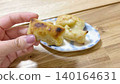 A hand eating kankoro mochi (right margin) 140164631