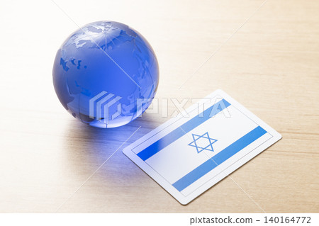A glass globe and the Israeli flag A glass globe and the Israeli flag 140164772