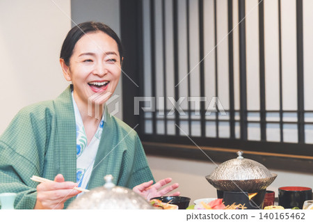 A woman eating dinner at a hot spring inn. A woman eating dinner at a hot spring inn. 140165462
