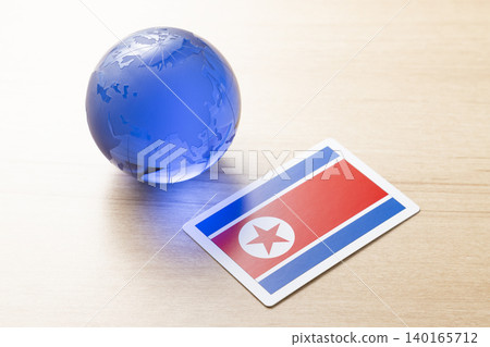A glass globe and the North Korean flag A glass globe and the North Korean flag 140165712